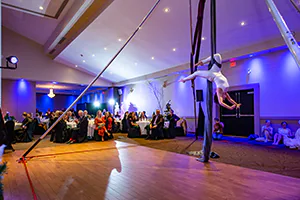 A gymnast performs before a fundraising event.   Audience perspective.  Event photo by Jeffrey Meyer 