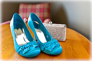 A bride shows off her shoes as something blue and something new